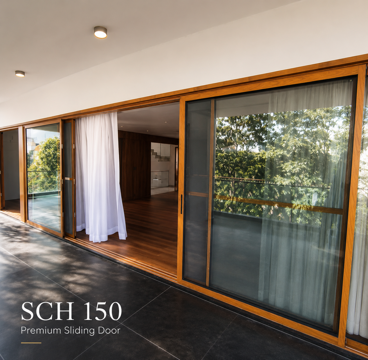 Wide interior shot featuring large SCHON sliding glass panels in a luxury living space with floor-to-ceiling glazing